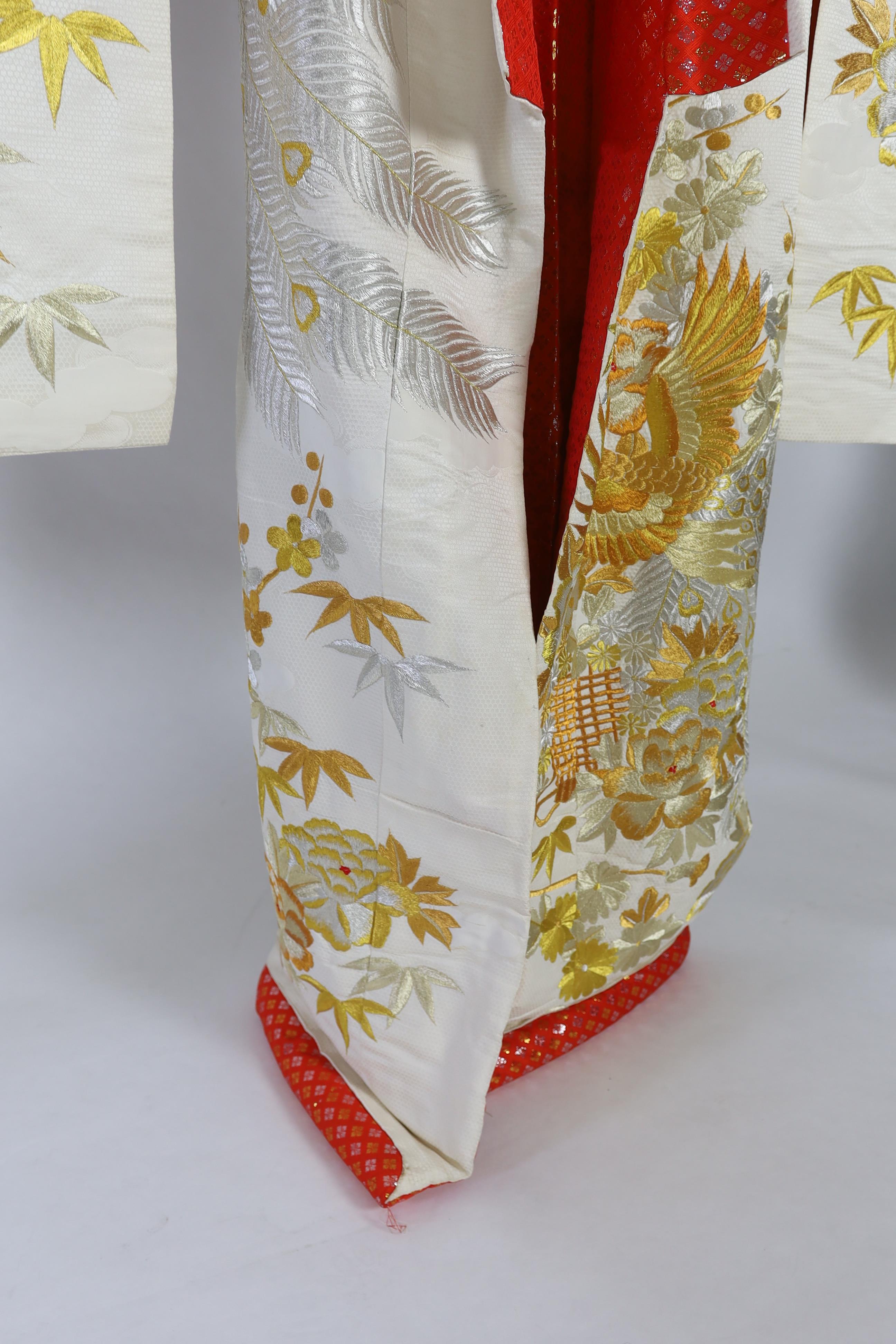 A 1960s-70s vintage Japanese embroidered wedding kimono, embroidered with pewter, bronze, silver and gold coloured metallic threads, into a large decorative design of peacocks with fanned tail feathers and trailing flowe